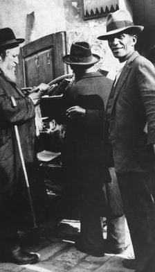 Examining tzitzit, Lemberg Ghetto, USSR, 1941-1944. Creator: Unknown