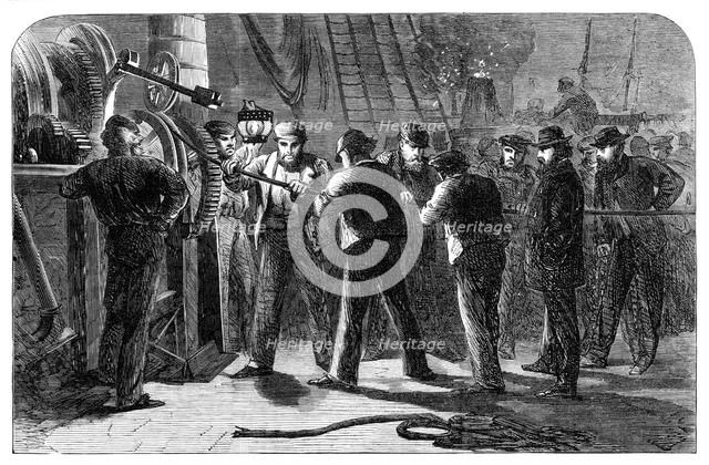 Examining the Atlantic Telegraph Cable, after raising it, on board the Great Eastern, 1865. Creator: Unknown.