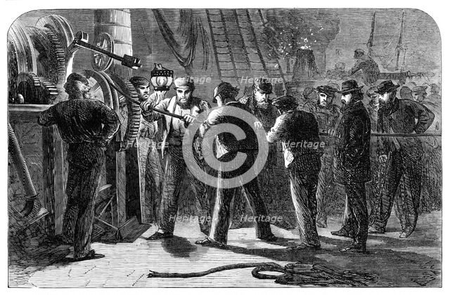 Examining the Atlantic Telegraph Cable, after raising it, on board the Great Eastern, 1865. Creator: Unknown.