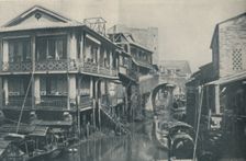 Fouled Waters Beneath A Bridge Leading To Unlovely Homes of Poverty and Pain c1935. Artist: ENA