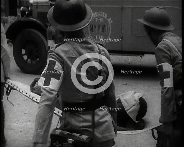 Four Chinese Red Cross Society of China Staff Carrying a Stretcher Supporting an Injured..., 1938. Creator: British Pathe Ltd.
