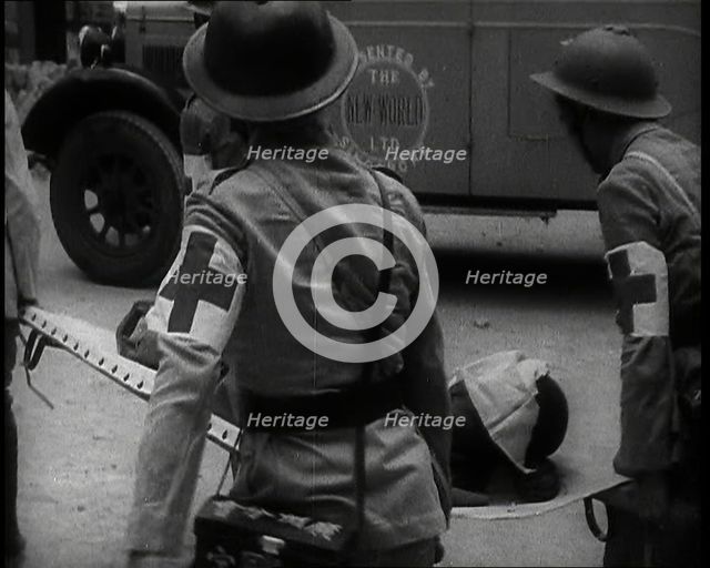Four Chinese Red Cross Society of China Staff Carrying a Stretcher Supporting an Injured..., 1938. Creator: British Pathe Ltd.