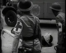 Four Chinese Red Cross Society of China Staff Carrying a Stretcher Supporting an Injured..., 1938. Creator: British Pathe Ltd