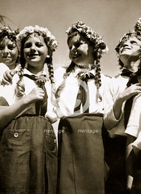 Four German girls smiling with garlands in their hair, c1936. Creator: Unknown.