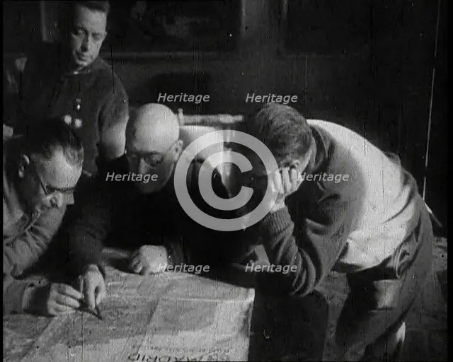 Four Men Consulting a Map in an Office, 1937. Creator: British Pathe Ltd.