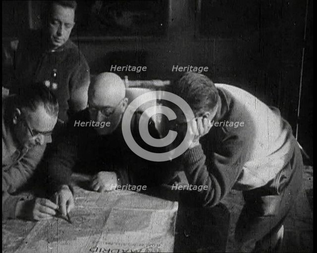 Four Men Consulting a Map in an Office, 1937. Creator: British Pathe Ltd.