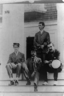 Four men, friends of Frances Benjamin Johnston, posed on porch, between 1900? and 1930. Creator: Frances Benjamin Johnston