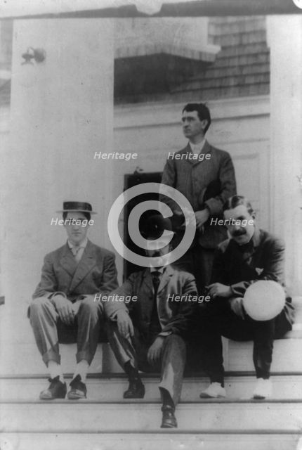 Four men, friends of Frances Benjamin Johnston, posed on porch, between 1900? and 1930. Creator: Frances Benjamin Johnston.