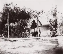 [Four men in camp under a lean-to of pine boughs], 1861-65. Creator: Unknown