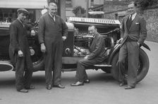 Four men posing beside a Minerva car. Artist: Bill Brunell
