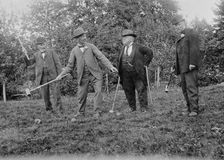 Four men playing croquet