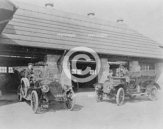 Four men with two automobiles outside of garage of Edmund Cogswell..., Greenwich, Connecticut, 1908. Creator: Frances Benjamin Johnston.