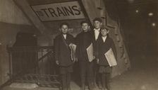 Four Newsies at an Entrance to the Subway, New York City, 1910. Creator: Lewis Wickes Hine