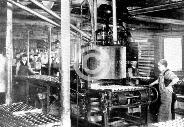 Fourteen thousand tins an hour! A machine that fills tins of "shoeshine", 1909. Creator: Unknown.