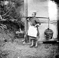 Foochow, Fukien province, China: a woman carrying buckets of night-soil, 1871. Creator: John Thomson