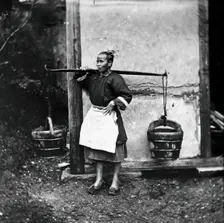 Foochow, Fukien province, China: a woman carrying buckets of night-soil, 1869 (1981). Creator: John Thomson