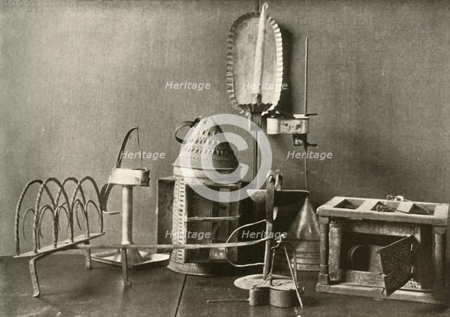'Foot-warmer; oil lamps; candle sconce; tin lantern; and toaster', c18th century, (1937).  Creator: Unknown.