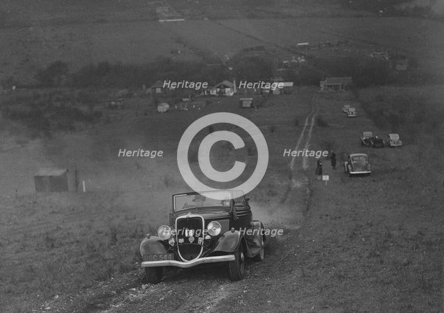 Ford V8 competing in the London Motor Club Coventry Cup Trial, Knatts Hill, Kent, 1938. Artist: Bill Brunell.