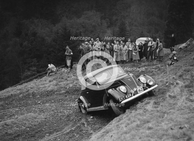 Ford V8 of J Cleland competing in the MCC Edinburgh Trial, Roxburghshire, Scotland, 1938. Artist: Bill Brunell.