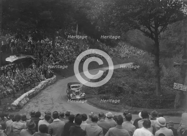 Ford V8 saloon competing in the Shelsley Walsh Hillclimb, Worcestershire, 1935. Artist: Bill Brunell.