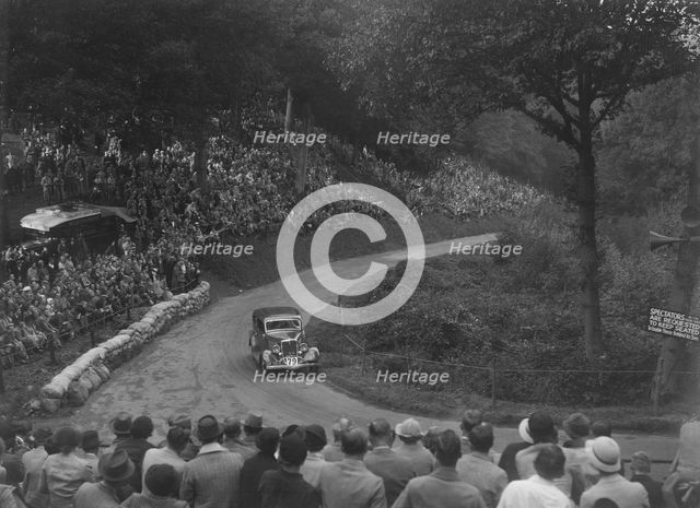 Ford V8 saloon competing in the Shelsley Walsh Hillclimb, Worcestershire, 1935. Artist: Bill Brunell.