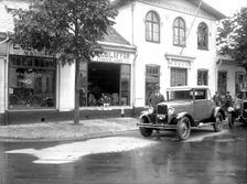 Ford car and driver outside a car company, Landskrona, Sweden, 1925. Creator: Unknown