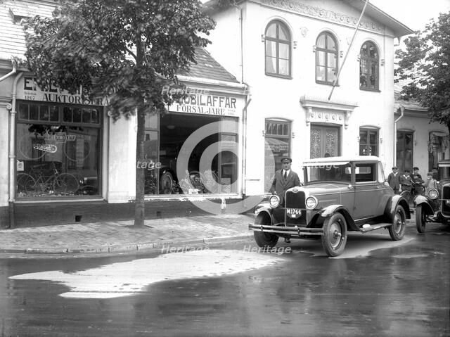 Ford car and driver outside a car company, Landskrona, Sweden, 1925. Artist: Unknown