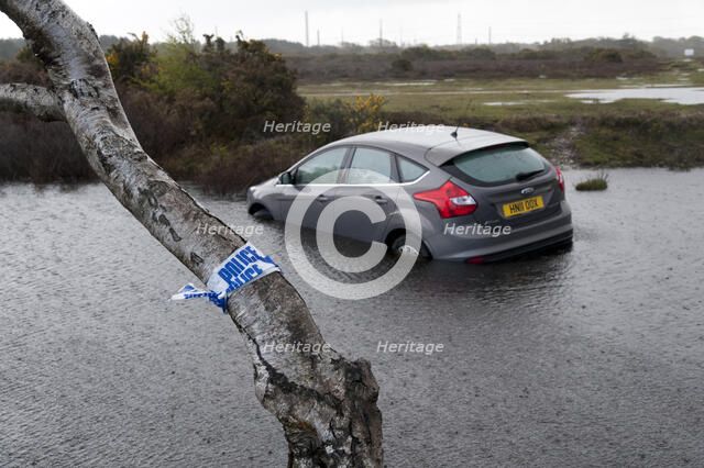 Ford Focus in flooded ditch after losing control on wet road 2012 Artist: Unknown.