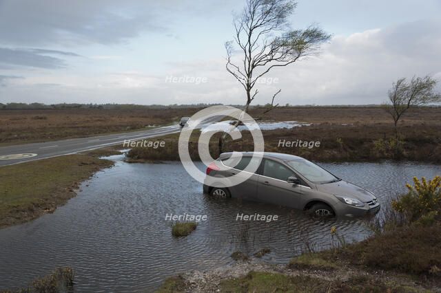 Ford Focus in flooded ditch after losing control on wet road 2012 Artist: Unknown.