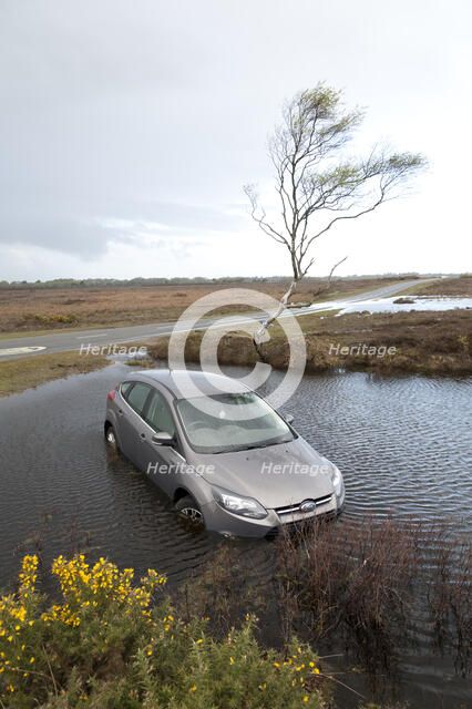 Ford Focus in flooded ditch after losing control on wet road 2012 Artist: Unknown.