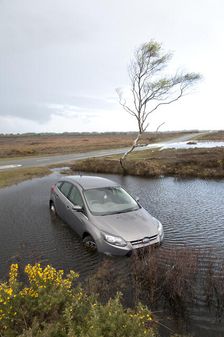 Ford Focus in flooded ditch after losing control on wet road 2012