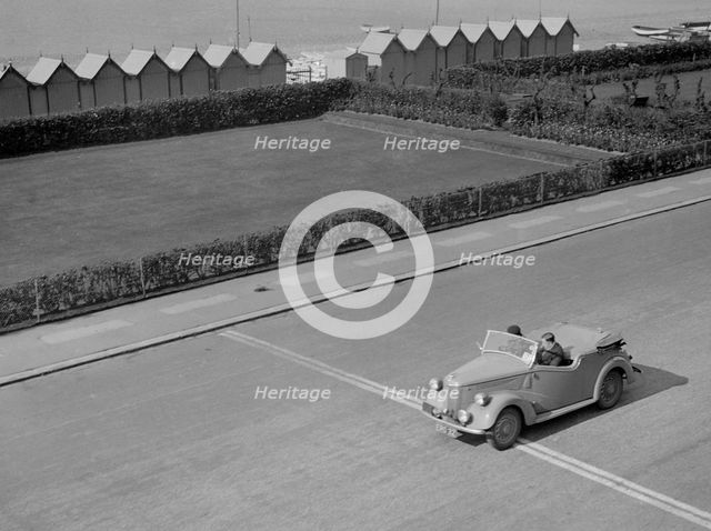 Ford Prefect tourer of JW Whalley competing in the RAC Rally, Madeira Drive, Brighton, 1939. Artist: Bill Brunell.