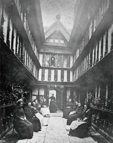 Ford's Hospital, Coventry: residents seated in the courtyard looking toward the street, c1880s. Creator: Unknown