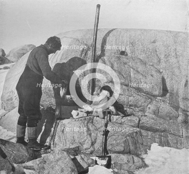 'Forde Cooking Seal-Fry on the Blubber Stove at Cape Roberts', c1911, (1913). Artist: Frank Debenham.