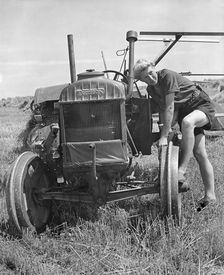 Fordson tractor, with Land girl 1940's. Creator: Unknown