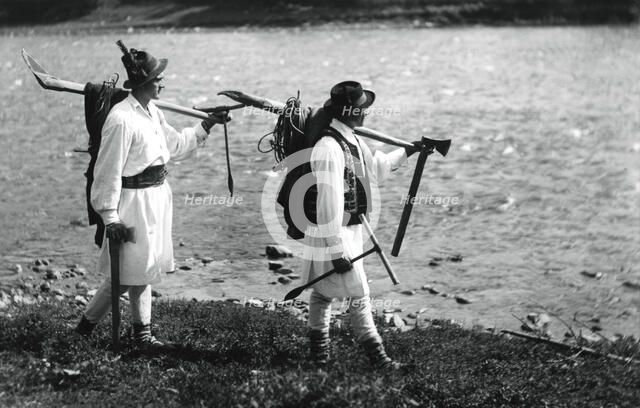 Foresters carrying their tools, Bistrita Valley, Moldavia, north-east Romania, c1920-c1945. Artist: Adolph Chevalier