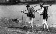 Foresters carrying their tools, Bistrita Valley, Moldavia, north-east Romania, c1920-c1945. Artist: Adolph Chevalier
