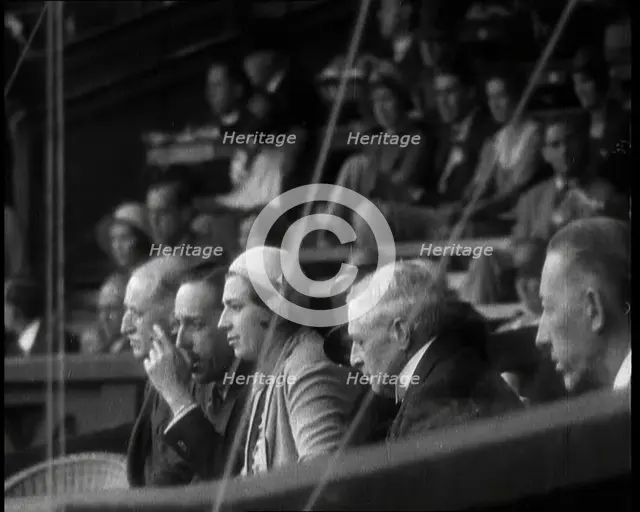 Former King Alphonso of Spain and His Wife, Victoria Eugenie of Battenberg Watching Tennis, 1930s. Creator: British Pathe Ltd.