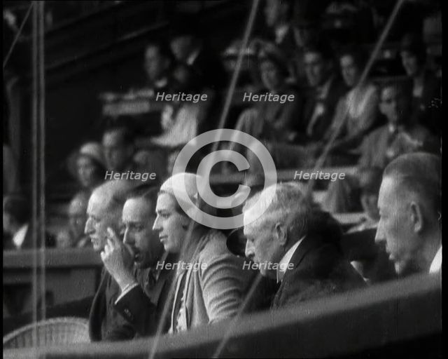 Former King Alphonso of Spain and His Wife, Victoria Eugenie of Battenberg Watching Tennis, 1930s. Creator: British Pathe Ltd.