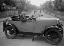 FA Thatcher behind the wheel of a 1929 Triumph Super Seven open four-seater. Artist: Bill Brunell