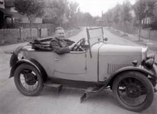 FA Thatcher behind the wheel of a 1929 Triumph Super Seven open four-seater. Artist: Bill Brunell