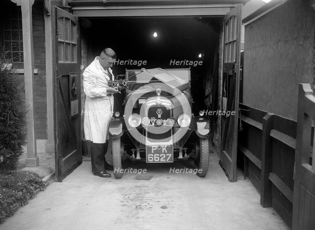 FA Thatcher working on his 1929 Triumph Super Seven. Artist: Bill Brunell.