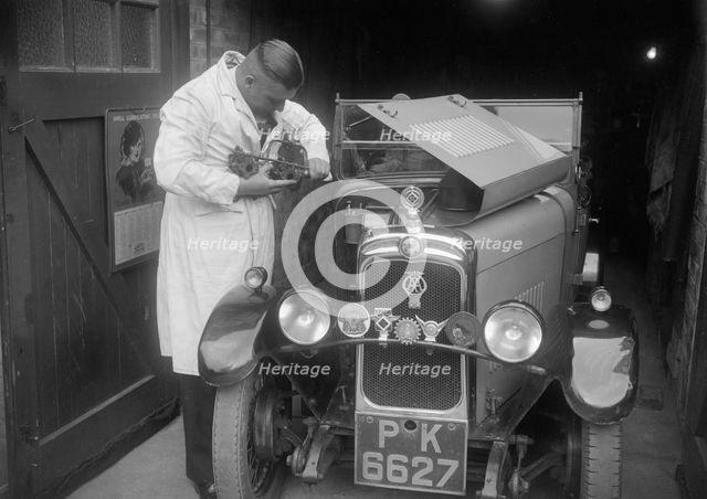 FA Thatcher working on his 1929 Triumph Super Seven. Artist: Bill Brunell.