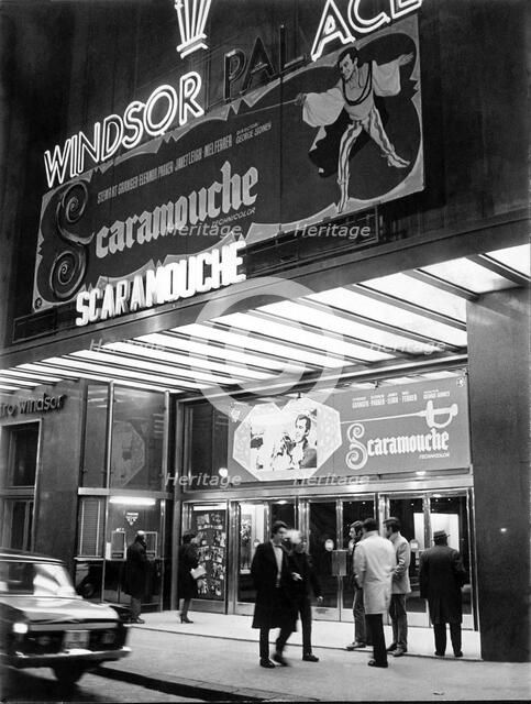 Façade of old cinema Windsor in Barcelona with neon signs advertising the film Scaromouche, 1952.