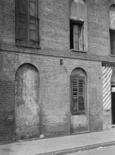 Facade of a multi-story building, New Orleans or Charleston, South Carolina, between 1920 and 1926. Creator: Arnold Genthe