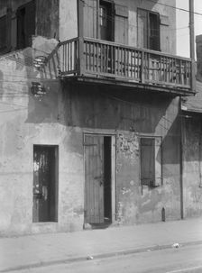 Facade of a multi-story house in the French Quarter, New Orleans, between 1920 and 1926. Creator: Arnold Genthe