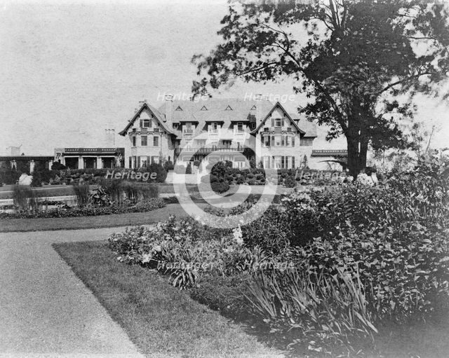 Facade of home of Edmund Cogswell Converse, with flowers in foreground, Greenwich, Connecticut, 1908 Creator: Frances Benjamin Johnston.