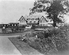 Facade of home of Edmund Cogswell Converse, with flowers in foreground, Greenwich, Connecticut, 1908 Creator: Frances Benjamin Johnston