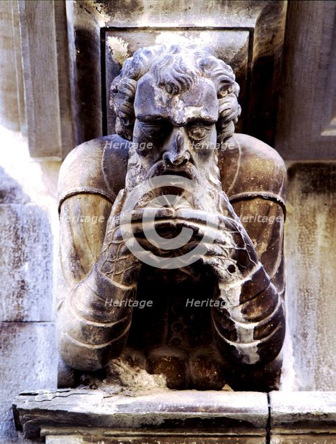 Façade of the Paeria of Cervera, anthropomorphic corbel of a personage stroking his beard.