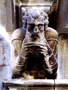 Façade of the Paeria of Cervera, anthropomorphic corbel of a personage stroking his beard